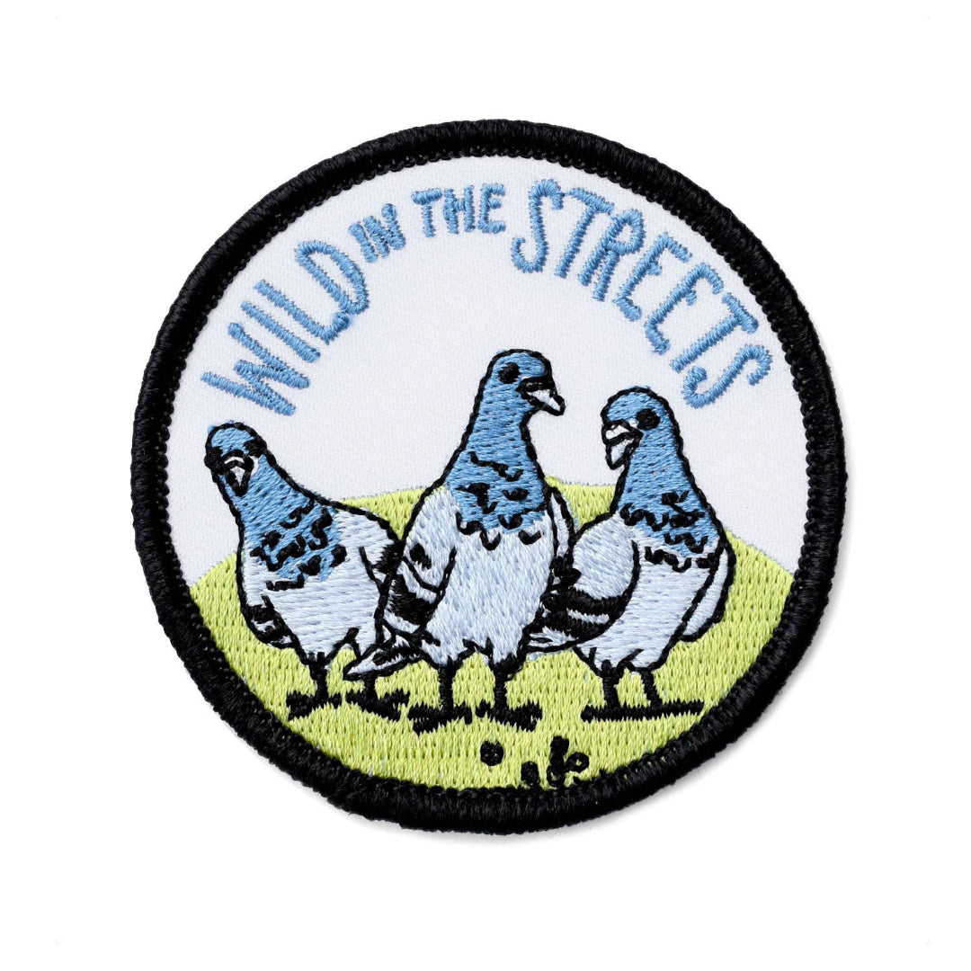 Embroidered patch with three pigeons and 'Wild in the Streets' text on a white background