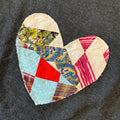 Heart-shaped patch with quilted design on a dark gray shirt