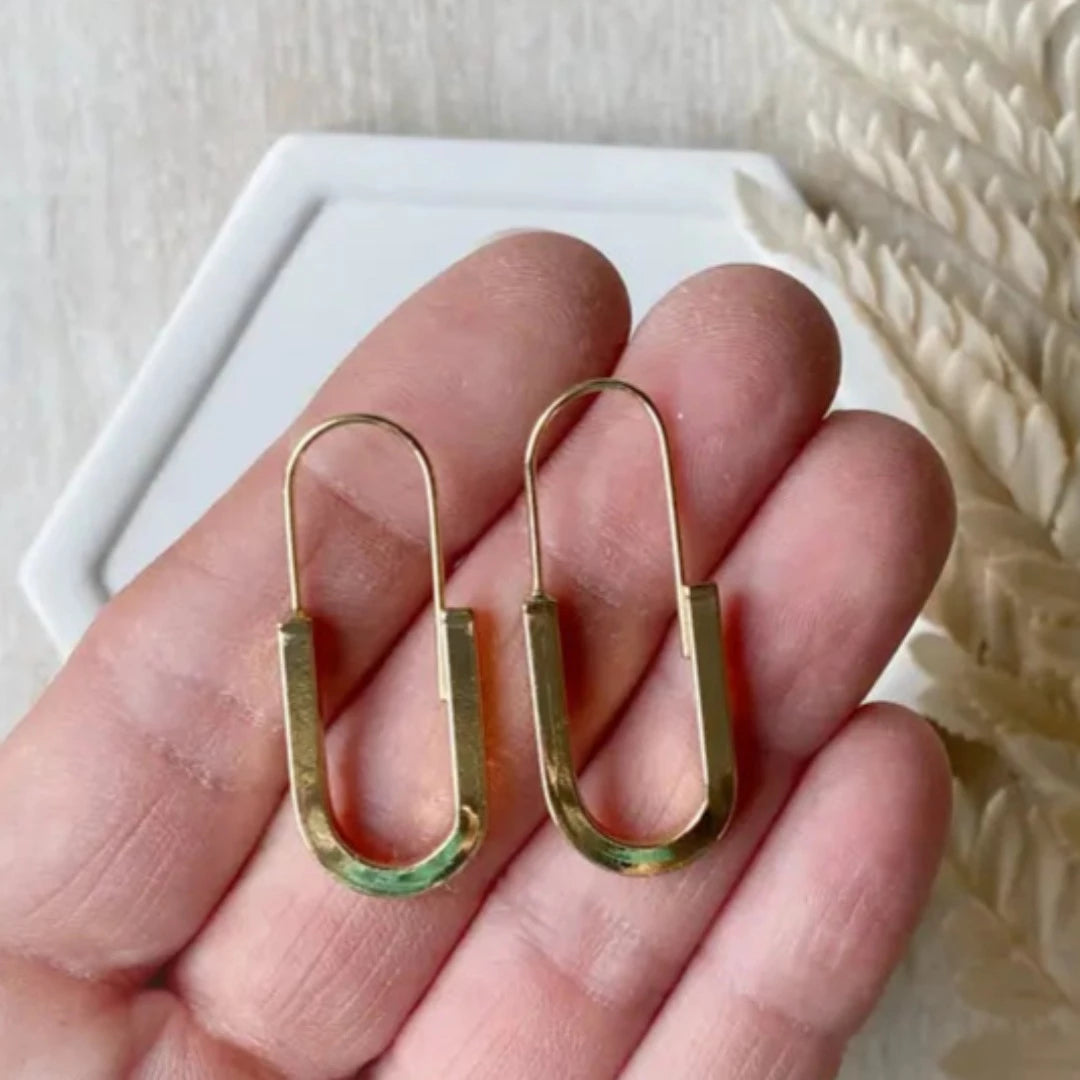 The Gold Minimalist Hoop is an ultra modern and sleek design and will be sure to keep you looking top notch. Nickel free and 14K gold plated.  Made in Canada. Close Up product image