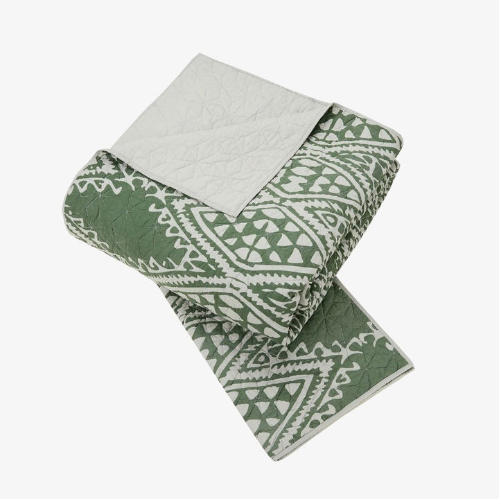 A green and white quilt set.