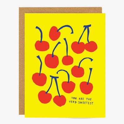 A yellow card covered in red cherries with blue stems and quote 