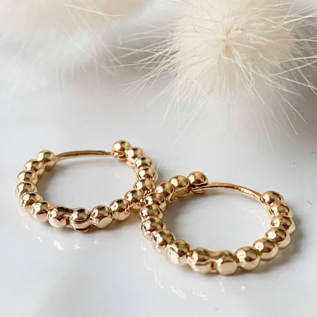 Gold Beaded Hoops. Gold hoop earrings made from gold beads connected into a circle.