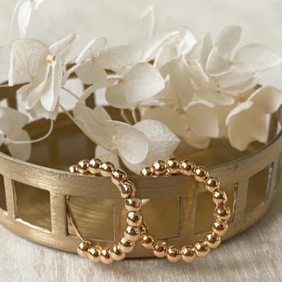 Gold Beaded Hoops. Gold hoop earrings made from gold beads connected into a circle.