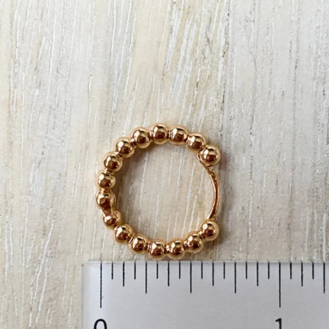 Gold Beaded Hoops. Gold hoop earrings made from gold beads connected into a circle.