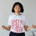 Person wearing a white t-shirt with red graphic design against a plain background