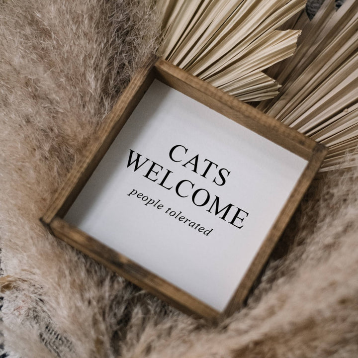 A white framed box sign with the text 