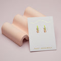 Foxy Originals earrings on a pink card with 'Good things are coming' text on a pink background