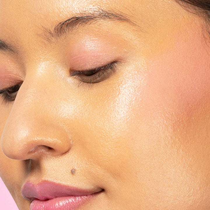 Red-dy or Not Lip & Cheek Tinted Balm, a liquid blush used on a medium skin toned woman's eyes, cheeks and lips.