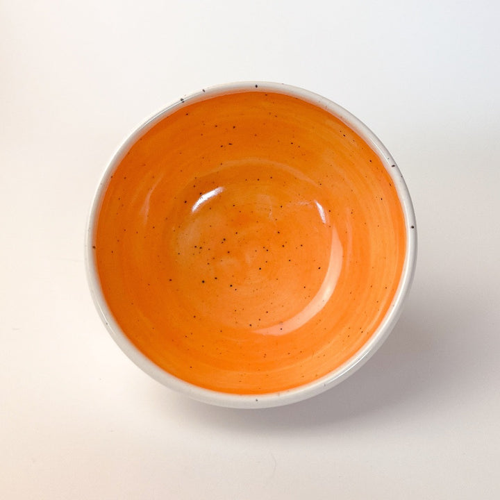 Orange Colourful Trinket Dish, a small bowls with colour on the inside and speckled cream coloured clay on the outside.