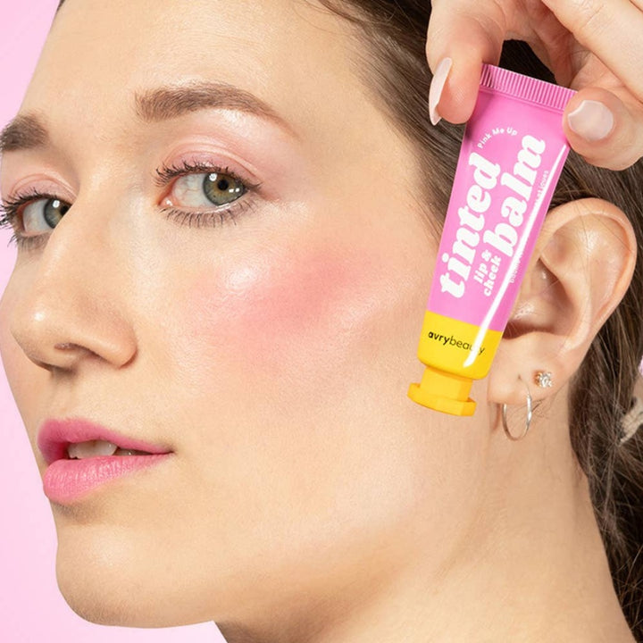 Red-dy or Not Lip & Cheek Tinted Balm, a liquid blush used on a white woman's eyes, cheeks and lips.