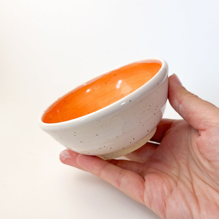 Orange Colourful Trinket Dish, a small bowls with colour on the inside and speckled cream coloured clay on the outside.