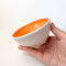 Orange Colourful Trinket Dish, a small bowls with colour on the inside and speckled cream coloured clay on the outside.