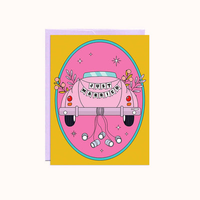A pink greeting card with a yellow envelope. The card features a pink vintage car with 