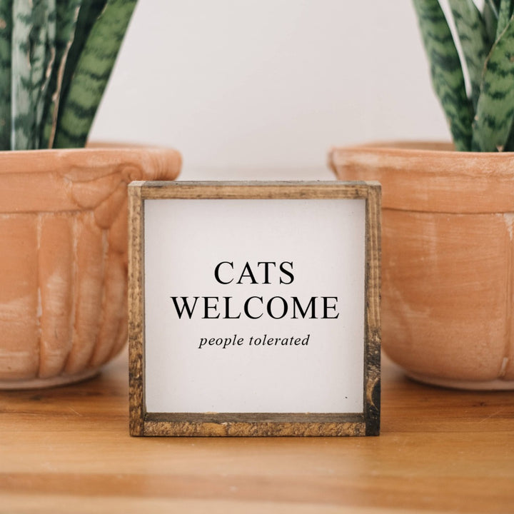 A white framed box sign with the text 