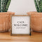A white framed box sign with the text 