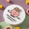 A pink cartoon brain with a smiling face is meditating. The brain has flowers growing from the top and is surrounded by the text 
