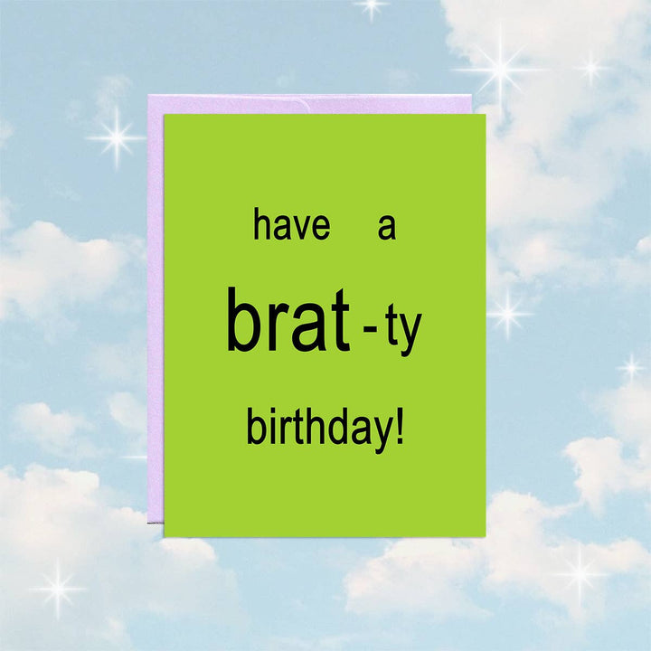 A bright green square card with a purple envelope. The card has the text 
