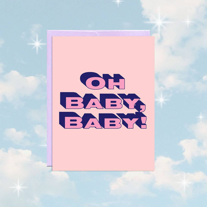 A pink greeting card with a light purple envelope. The card features the text 