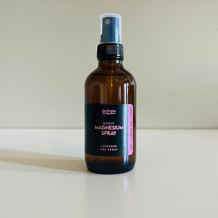 Lavender Magic Magnesium Spray, a body spray for sleep, chronic pain and anxiety in an amber bottle with a black sprayer.