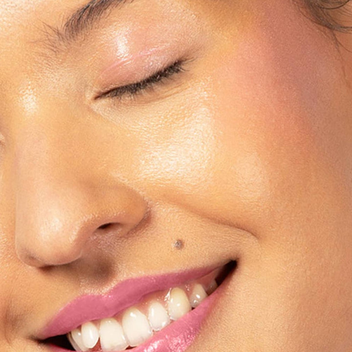 Red-dy or Not Lip & Cheek Tinted Balm, a liquid blush used on a medium skin toned woman's eyes, cheeks and lips.