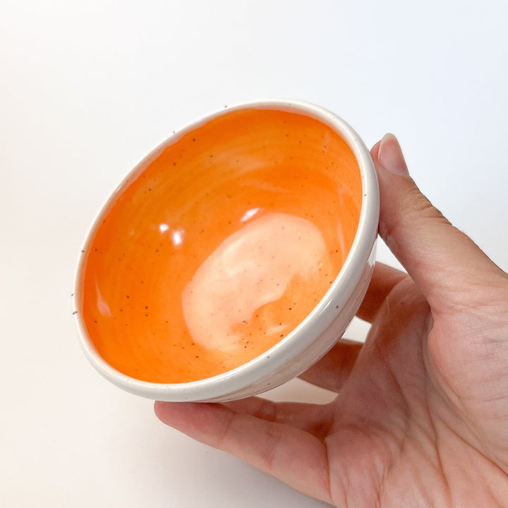 Orange Colourful Trinket Dish, a small bowls with colour on the inside and speckled cream coloured clay on the outside.