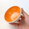 Orange Colourful Trinket Dish, a small bowls with colour on the inside and speckled cream coloured clay on the outside.