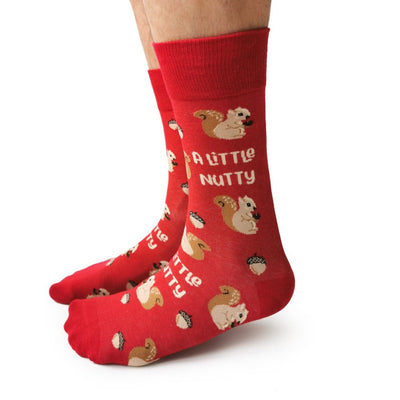 Red socks with squirrel and nut design on a white background