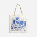 A white tote bag with a blue and white illustration. The illustration shows a plant on a windowsill, with a sink, soap, and other bathroom items visible. The text on the bag includes "Be Bold," "Find Your Fun," and "A lil' Somethin' Somethin' Epic Blend."