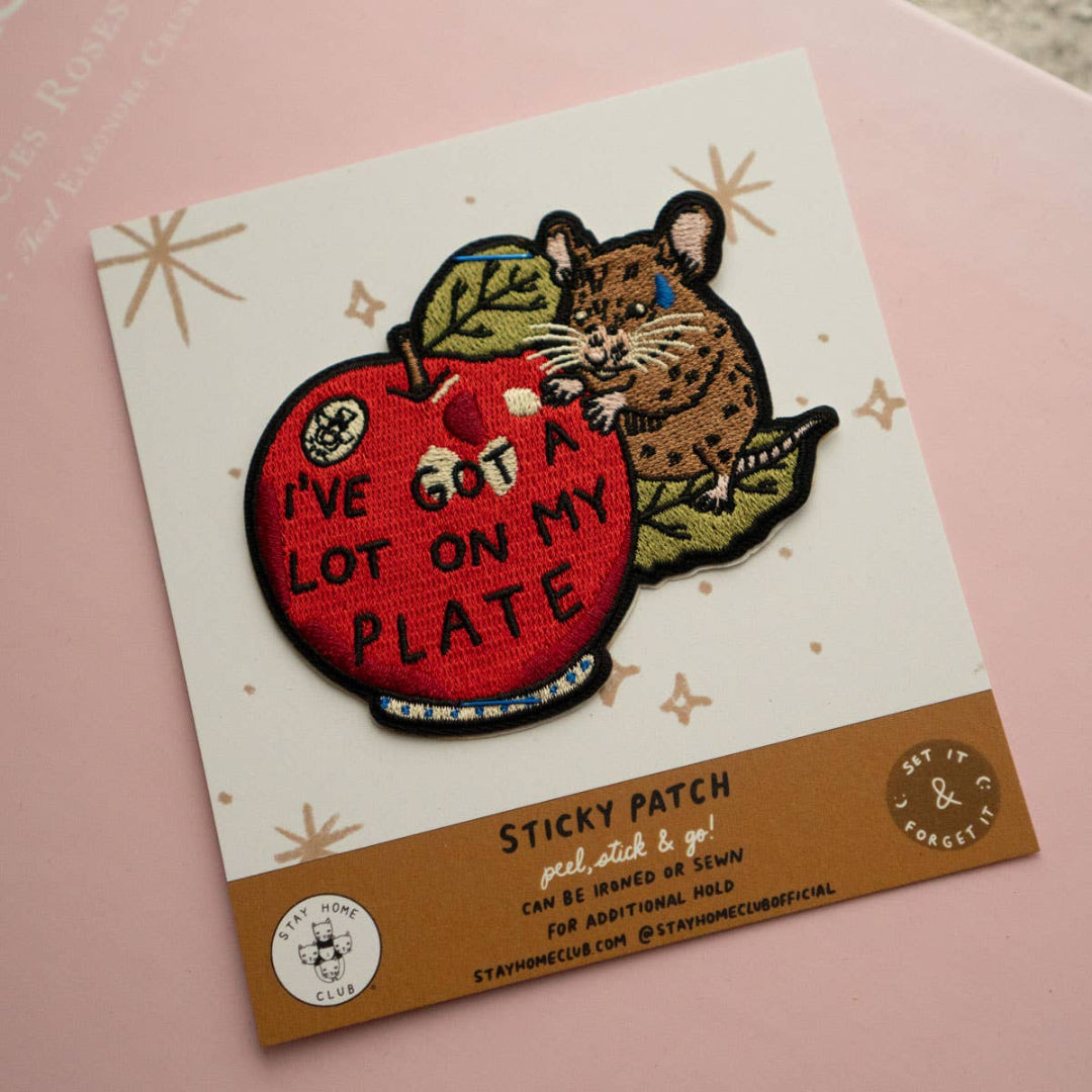 Sticky patch with a mouse and apple design on a pink background