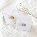 Two necklaces on display cards with 'Birch Jewellery' branding on a textured white surface.
