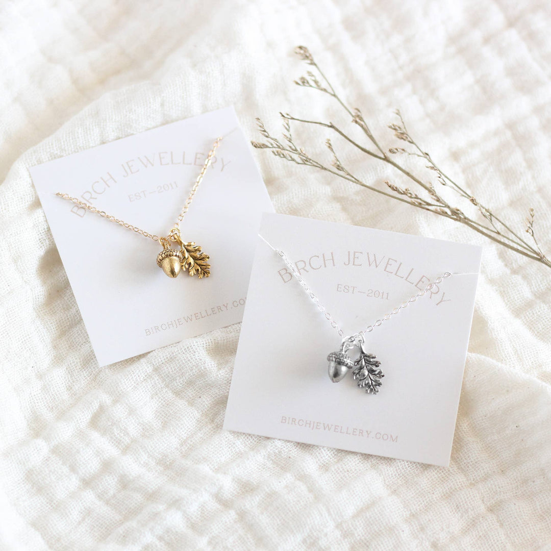 Two necklaces on display cards with 'Birch Jewellery' branding on a textured white surface.