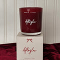 Red candle labeled 'Afterglow' by North & Rose on a matching box against a neutral background.