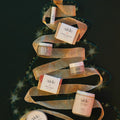 Skincare products arranged in a decorative ribbon on a dark background