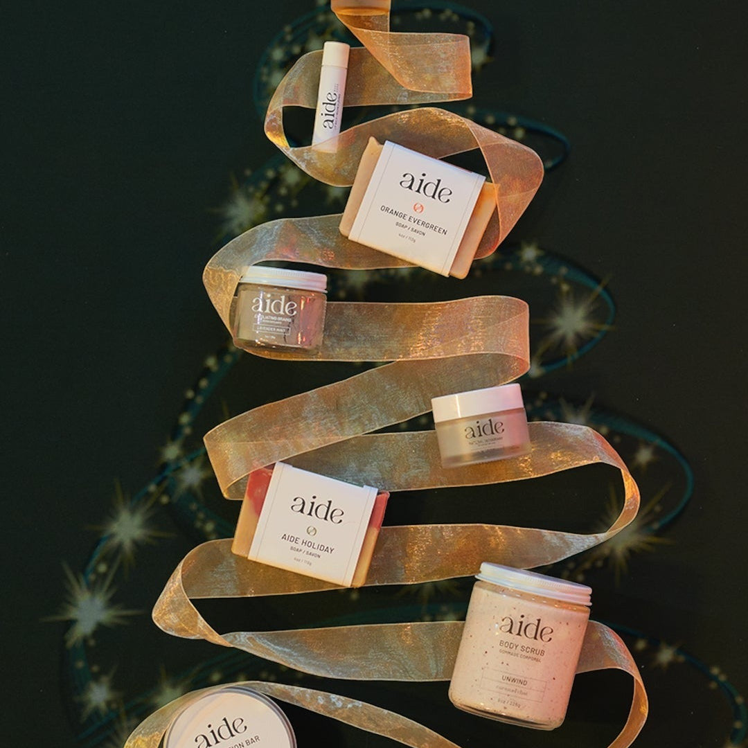 Skincare products arranged in a decorative ribbon on a dark background