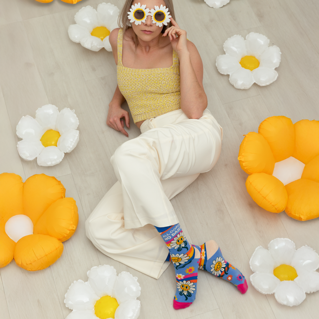 Woman lying on a floor with floral decorations and colorful socks