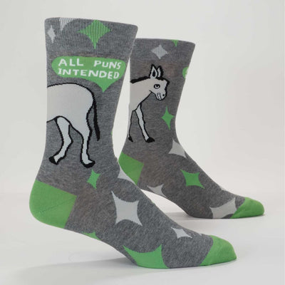A pair of men's crew socks with a grey background and a pattern of white starbursts and green accents. One sock features the rear end of a white donkey and the text 