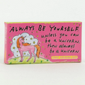 A pink box of fruit-flavored chewing gum. The front of the box features a drawing of a pink unicorn with a rainbow mane standing in a field of stars. The text "ALWAYS BE YOURSELF unless you can be a UNICORN, then always be a UNICORN" is printed above the unicorn.