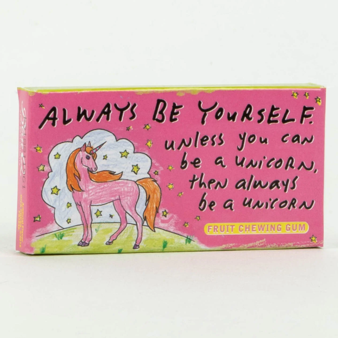 A pink box of fruit-flavored chewing gum. The front of the box features a drawing of a pink unicorn with a rainbow mane standing in a field of stars. The text "ALWAYS BE YOURSELF unless you can be a UNICORN, then always be a UNICORN" is printed above the unicorn.