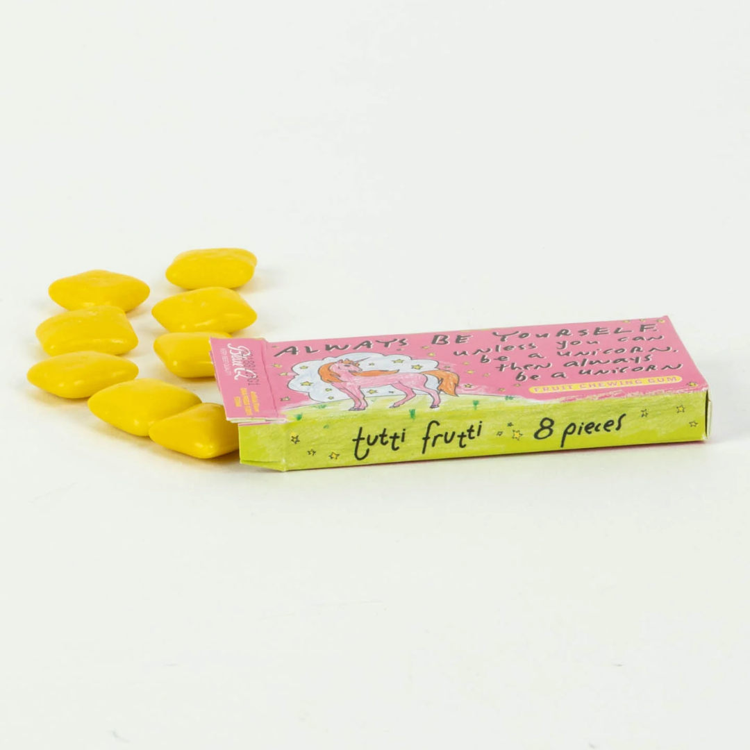A pink box of fruit-flavored chewing gum. The front of the box features a drawing of a pink unicorn with a rainbow mane standing in a field of stars. The text "ALWAYS BE YOURSELF unless you can be a UNICORN, then always be a UNICORN" is printed above the unicorn.