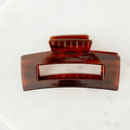 Brown hair clip on a white background