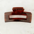 Brown hair clip on a white background