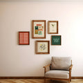 Framed artwork on a wall with a chair in front