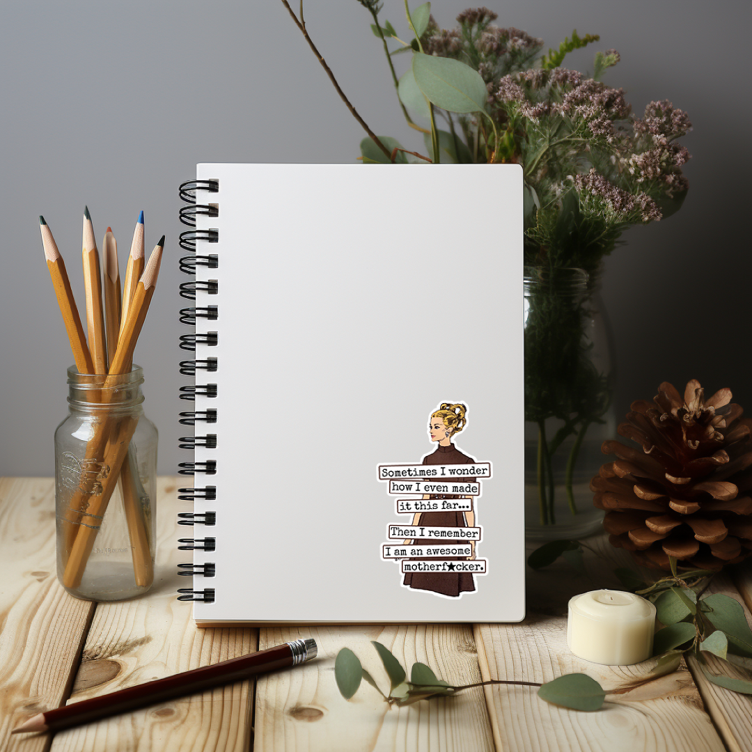 Notebook with a printed quote on a wooden surface with stationery items and flowers.