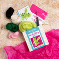 Crafting kit with felt pieces and tools on a textured surface