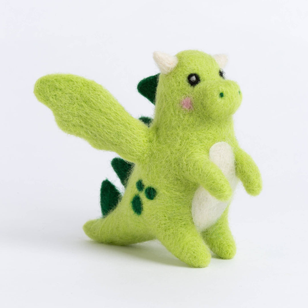 Green plush dinosaur toy on a white background