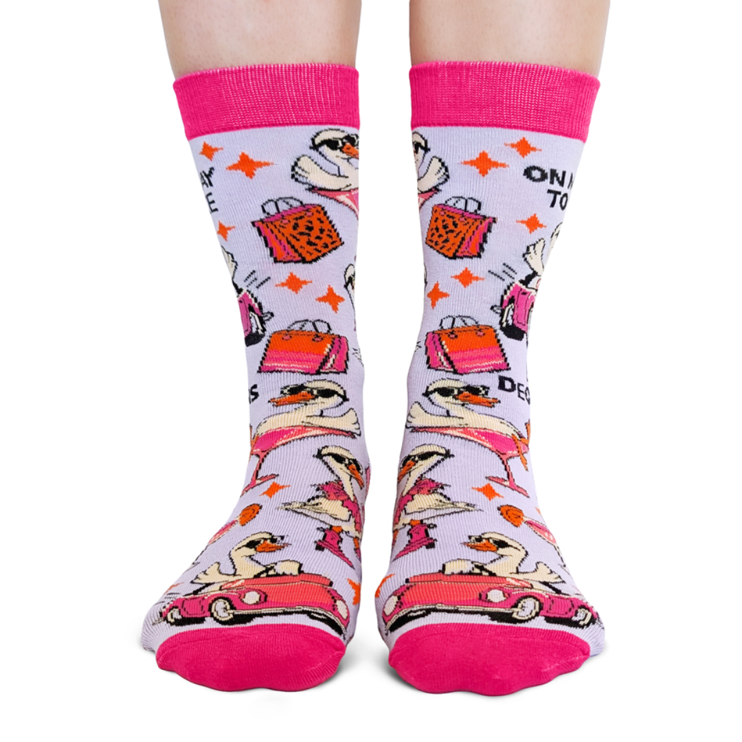 Colorful socks with cartoon characters and text on a white background