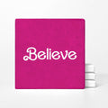 Pink notebook with 'Believe' text on a white background
