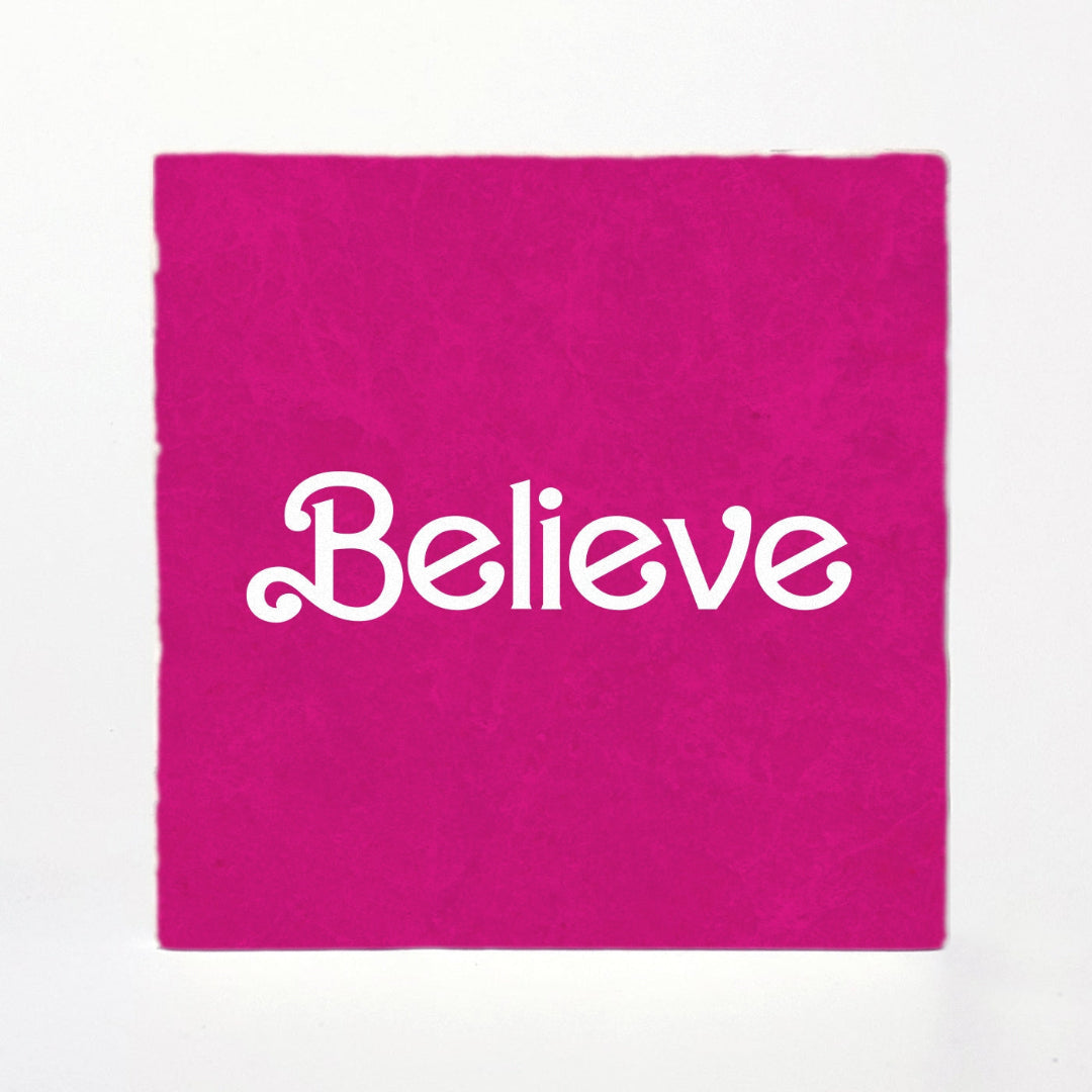 Pink fabric with 'Believe' printed in white on a white background