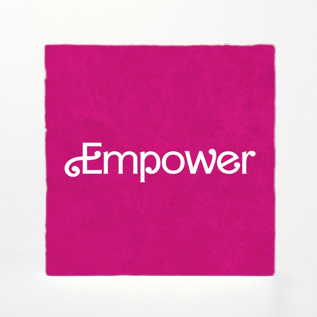 Pink fabric with 'Empower' text on a white background