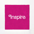 Pink fabric with 'Inspire' text on a white background